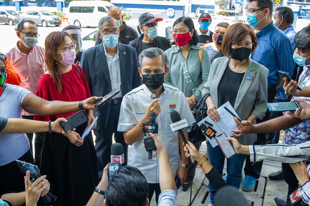 Lembah Pantai MP Fahmi Fadzil (centre) and the other Pakatan Harapan MPs speak to reporters outside the Dang Wangi police station in Kuala Lumpur May 4, 2021. u00e2u20acu2022 Picture by Shafwan Zaidon