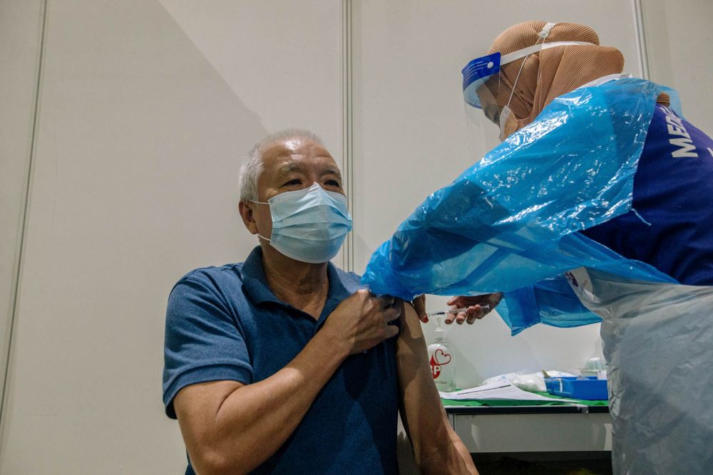 A nurse administers a dose of the AstraZeneca Covid-19 vaccine at the World Trade Centre Kuala Lumpur vaccination centre May 16, 2021. — Picture by Firdaus Latif