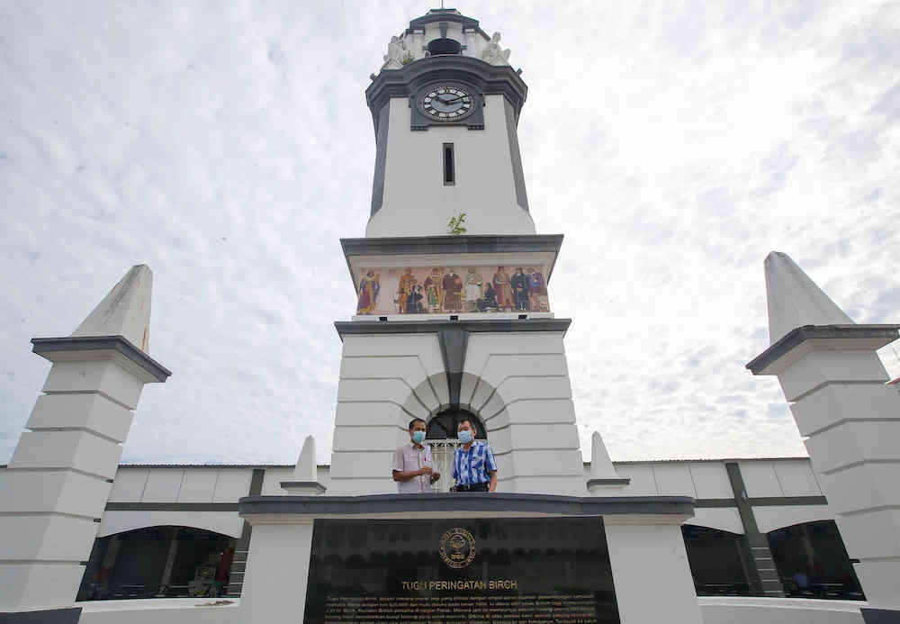 Time Recorder Sdn Bhd sales managers, Ui Foo Ming 53 (left) and Choo Kok Leong at the Birch Memorial Clock Tower, in Ipoh. — Picture by Farhan Najib 
