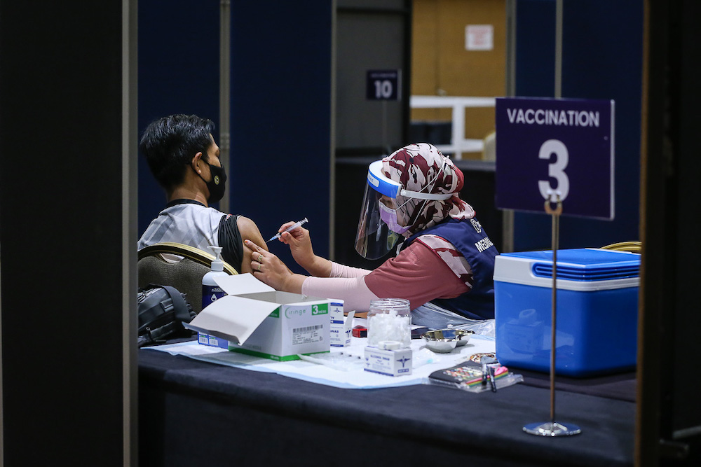 Manufacturing workers in Selangor receive their Pikas Covid-19 jab at the vaccination centre at Setia City Convention Centre in Shah Alam June 28, 2021. — Picture by Yusof Mat Isa