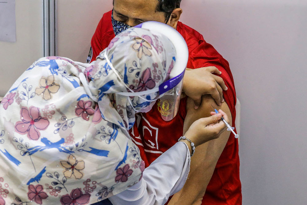 A man gets a Covid-19 vaccination at the Universiti Teknologi Mara in Shah Alam, June 23, 2021. ― Picture by Hari Anggara