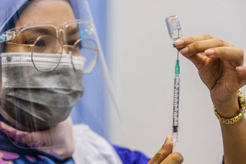 Health personnel prepare a syringe for Covid-19 vaccination at Universiti Teknologi Mara Shah Alam, June 23, 2021. ― Picture by Hari Anggara