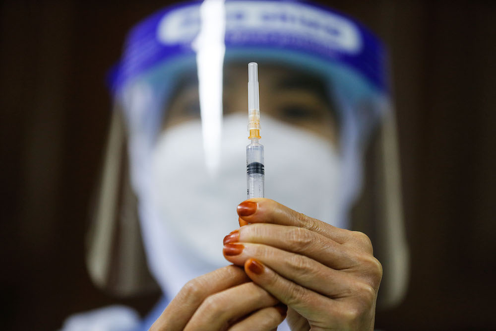 A nurse prepares the vaccine during the vaccination session for Persons with Disabilities in St Nicholas Home, Bagan Jermal July 5, 2021. — Picture by Sayuti Zainudin