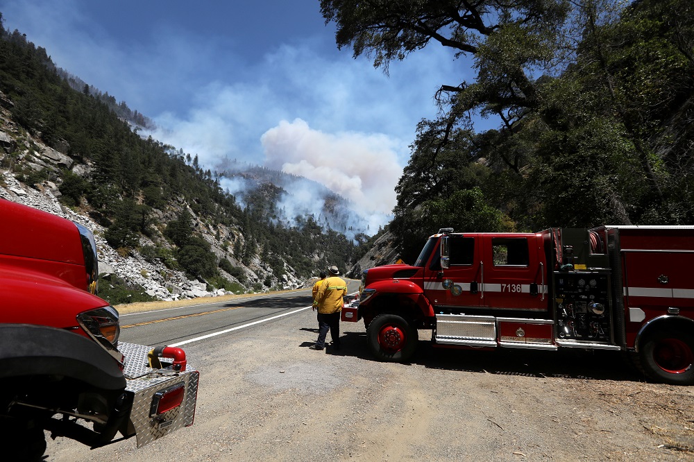 Firefighter monitor the advance as the Dixie Fire grows in Plumas National Forest, California July 15, 2021. — Reuters pic