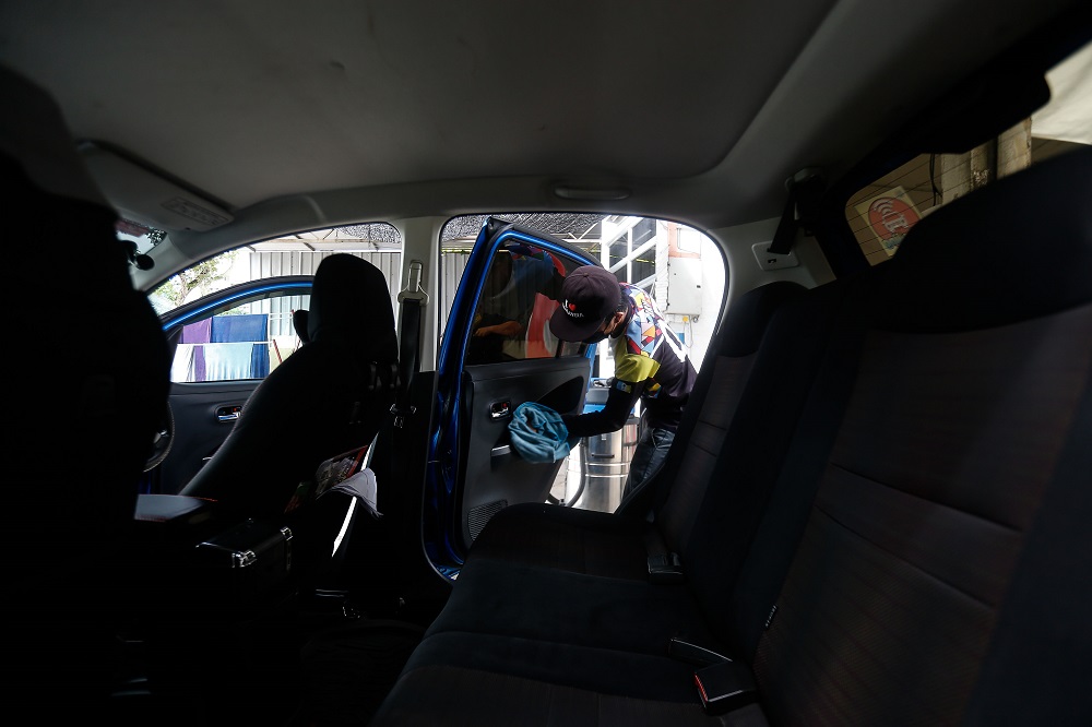 A staff cleans a vehicle at the Rainforest Car Care Centre in George Town July 7, 2021. -— Picture by Sayuti Zainudin