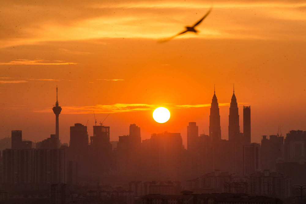 Malaysia’s landmark Petronas Twin towers and Kuala Lumpur Tower are seen as the sun sets over the Kuala Lumpur skyline in Ampang July 20, 2021. — Picture by Firdaus Latif