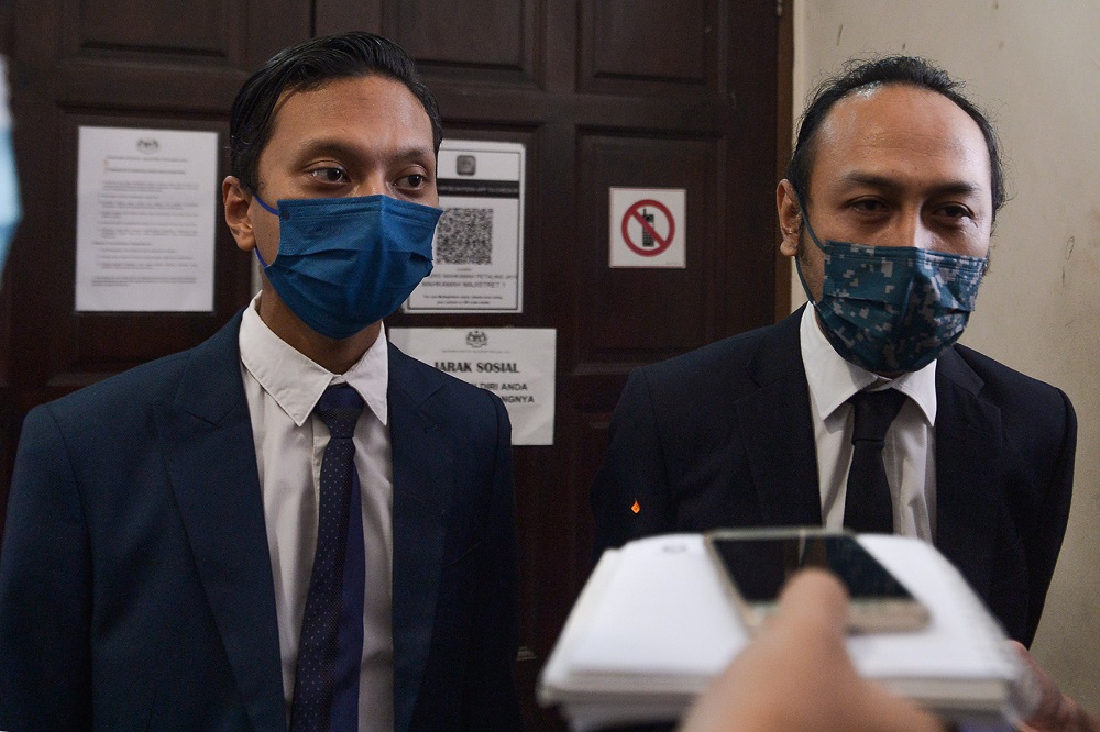 Lawyers Edly Mohammad Firdaus (left) and Mohd Haijan Omar (right) speak to reporters at the Petaling Jaya Magistrate Court July 21, 2021. — Picture by Miera Zulyana