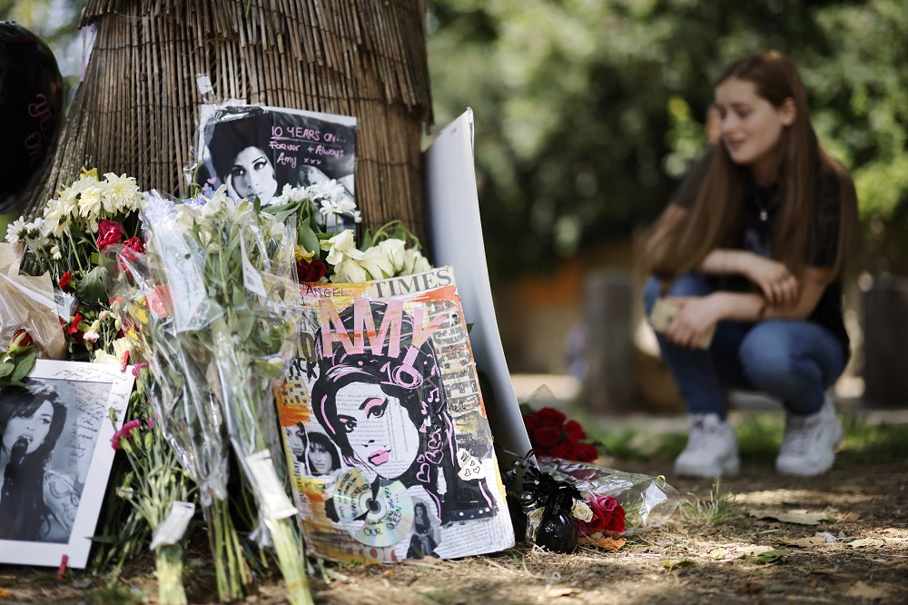 Fans gather at a temporary shrine close to the former house of British singer Amy Winehouse in north London. u00e2u20acu201d AFP pic