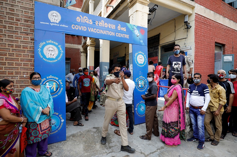 A police officer manages people who came to receive a dose of a Covid-19 vaccine outside a vaccination centre in Ahmedabad, India June 30, 2021. u00e2u20acu2022 Reuters pic