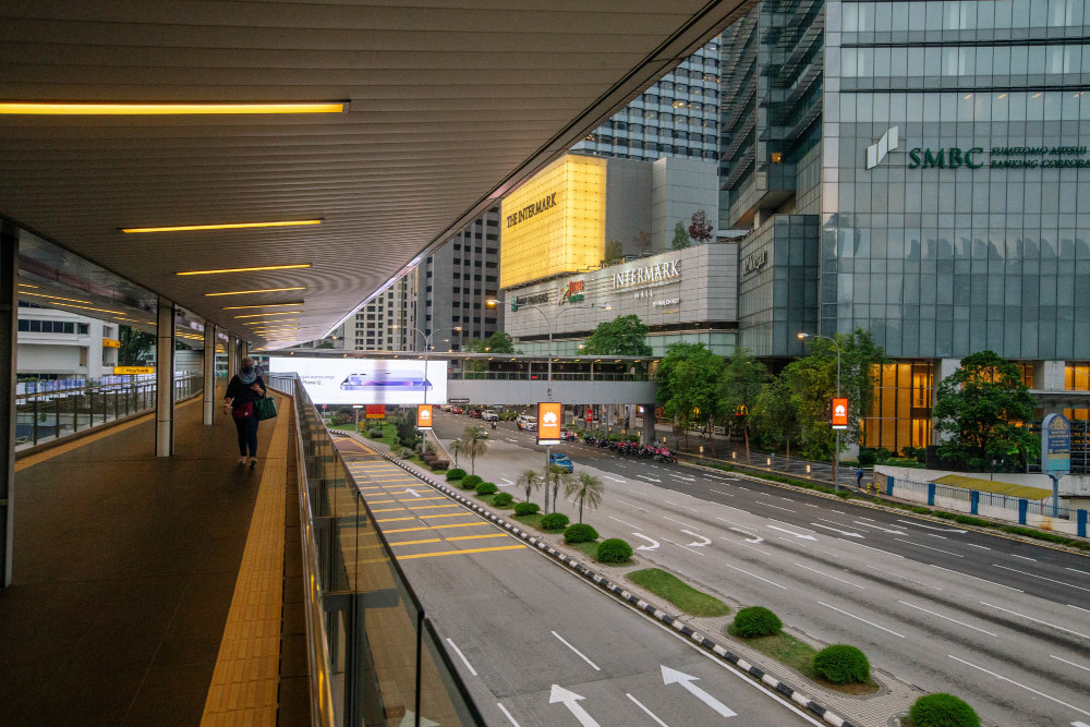 A pedestrian walks along an elevated walkway in Kuala Lumpur July 1, 2021. — Picture by Firdaus Latif 