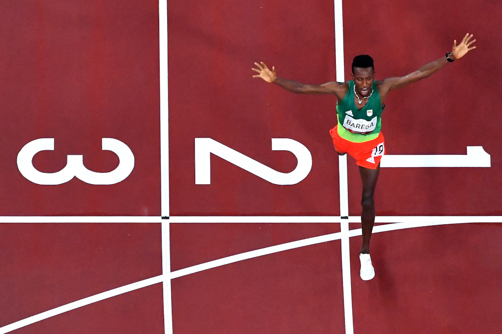 An overview shows Ethiopiau00e2u20acu2122s Selemon Barega as he crosses the finish line to win menu00e2u20acu2122s 10,000m final during the Tokyo 2020 Olympic Games at the Olympic Stadium in Tokyo July 30, 2021. u00e2u20acu201d AFP picnn
