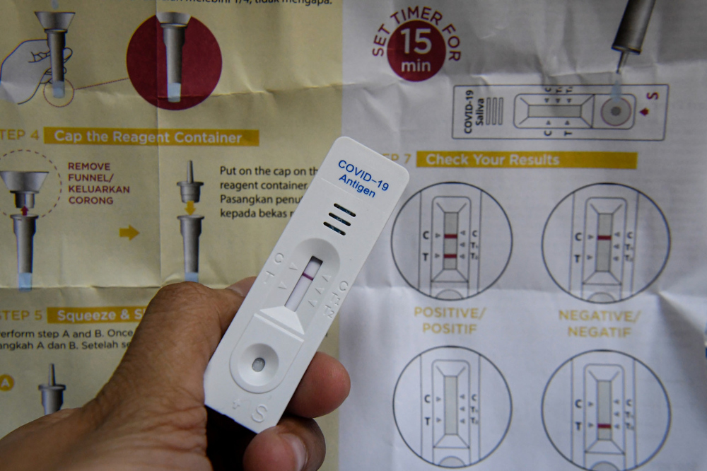 A negative result is shown after a 15-minute wait from the use of the Korean-made GMate Covid-19 Ag Saliva Home Kit, which can now be purchased at a CareMax Pharmacy in Setapak. u00e2u20acu201d Bernama pic 