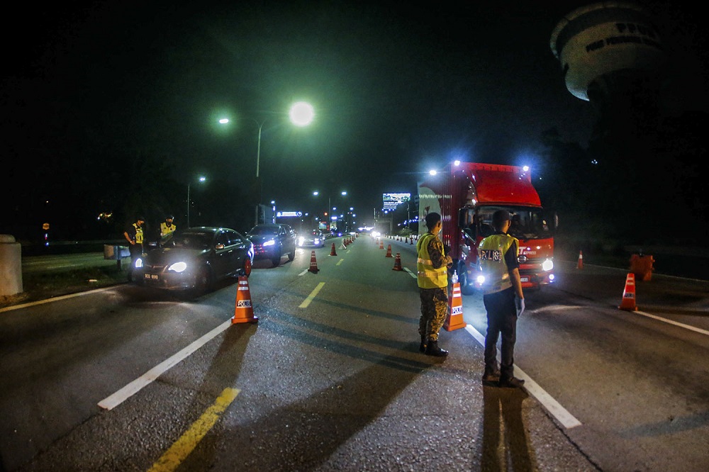 Police and army personnel man a roadblock at KM34 of the Federal Highway in Kuala Lumpur June 2, 2021. ― Picture by Hari Anggara