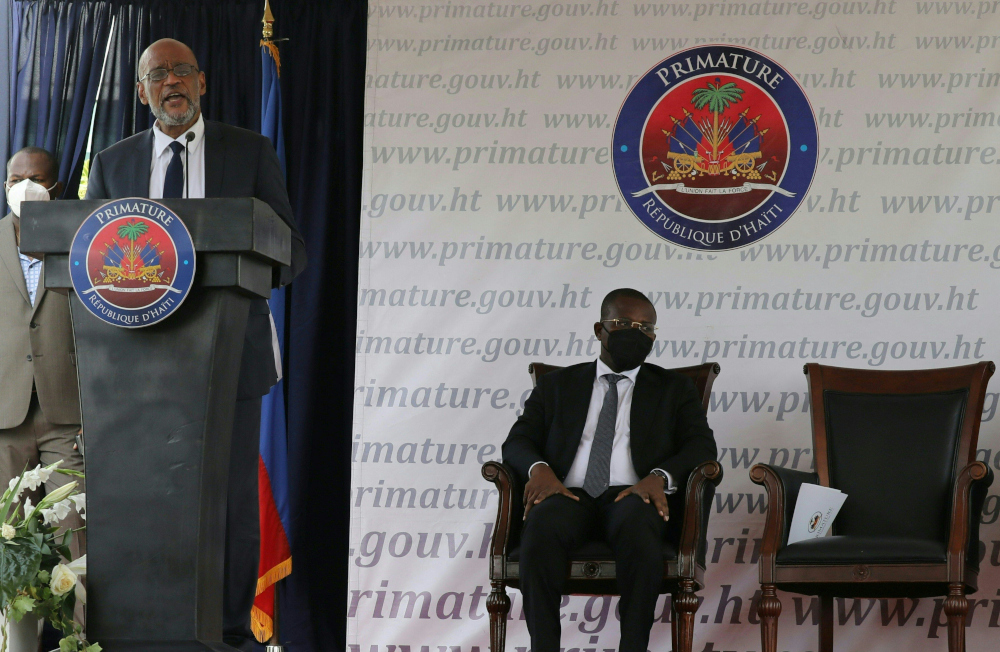 Interim Prime Minister Claude Joseph (right) listens as designated Prime Minister Ariel Henry speaks during a ceremony at La Primature in Port-au-Prince, Haiti, July 20, 2021. u00e2u20acu201d AFP picnn