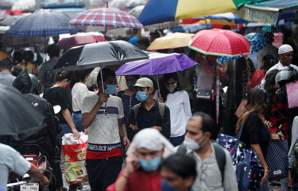 People walk through a crowded market on a rainy day amidst the spread of the coronavirus disease in Mumbai, India, July 14, 2021. u00e2u20acu201d Reuters pic 