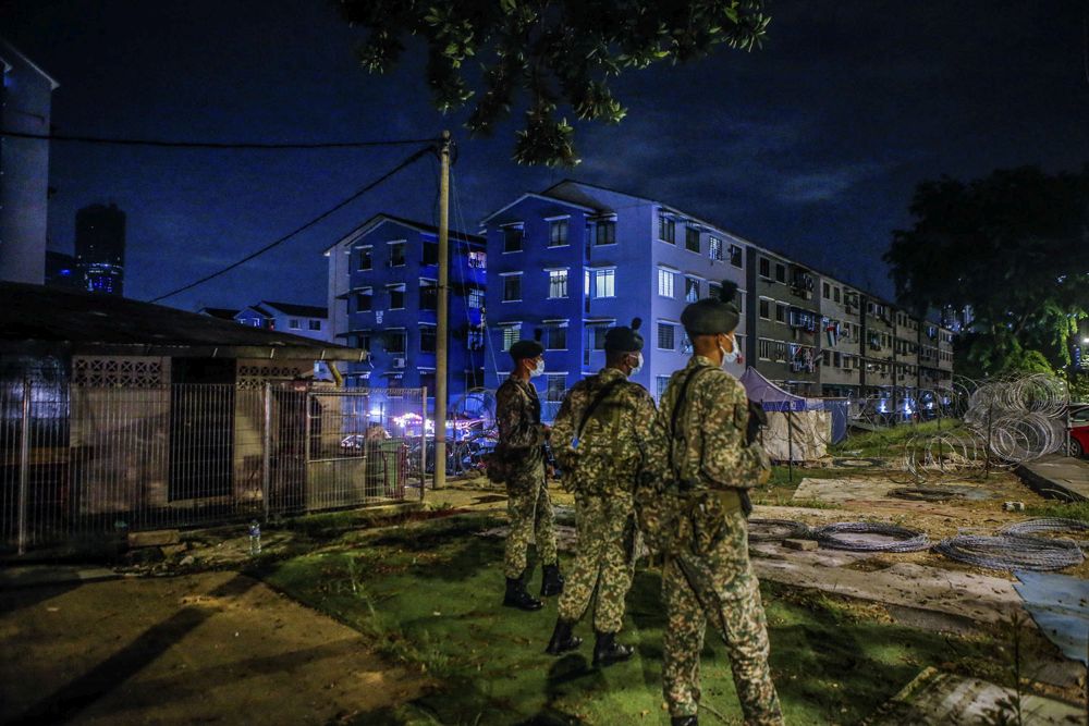 Armed Forces personnel stand guard in the vicinity of the Taman Bukit Angkasa flat buildings in Kuala Lumpur June 30, 2021. u00e2u20acu2022 Picture by Hari Anggarann