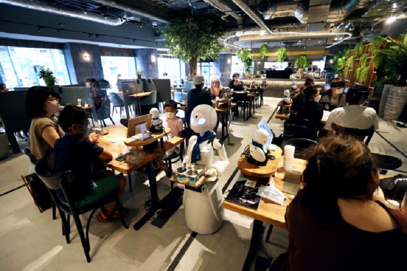 A humanoid robot delivers drinks to customers at the Dawn Cafe in Tokyo.  — AFP pic