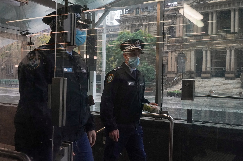 Masked police officers exit a transit station in the quiet city centre during a lockdown to curb the spread of a Covid-19 outbreak in Sydney, Australia August 24, 2021. u00e2u20acu2022 Reuters pic