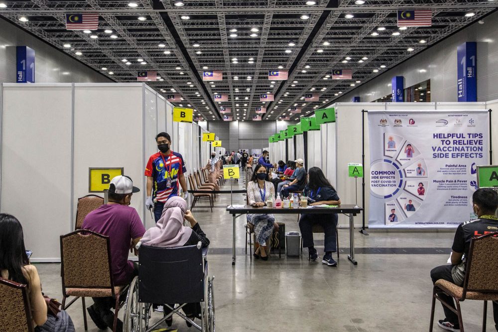 People wait to receive their Covid-19 jab at the KLCC vaccination centre in Kuala Lumpur August 31, 2021.  u00e2u20acu201d Picture by Firdaus Latif