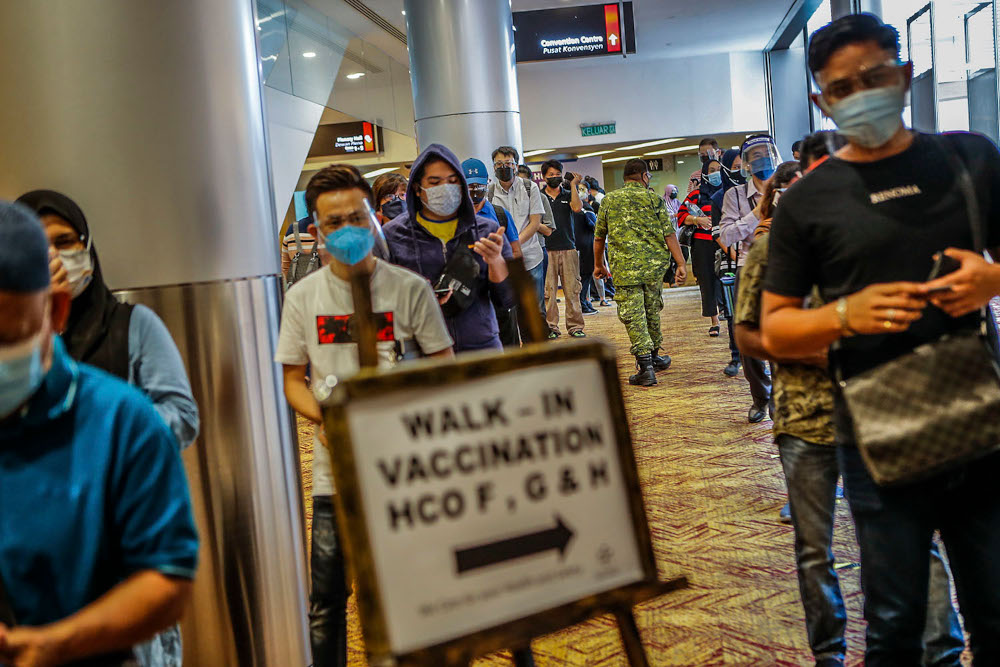 Walk-in vaccine recipients queue up for registration for their Covid-19 jabs at the Kuala Lumpur Convention Centre vaccination centre, August 2, 2021. ― Picture by Hari Anggara