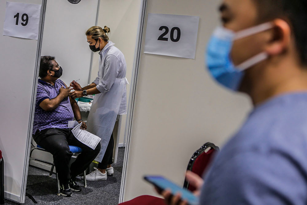 Walk-in vaccine recipients receive their Covid-19 jabs at the Kuala Lumpur Convention Centre vaccination centre, August 2, 2021. ― Picture by Hari Anggara