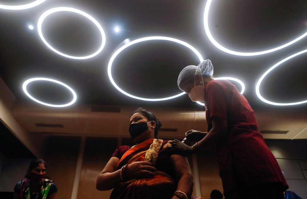 A woman reacts as she receives a dose of Covishield, a vaccine manufactured by Serum Institute of India, at a shopping mall in Mumbai, India August 11, 2021. u00e2u20acu2022 Reuters file pic