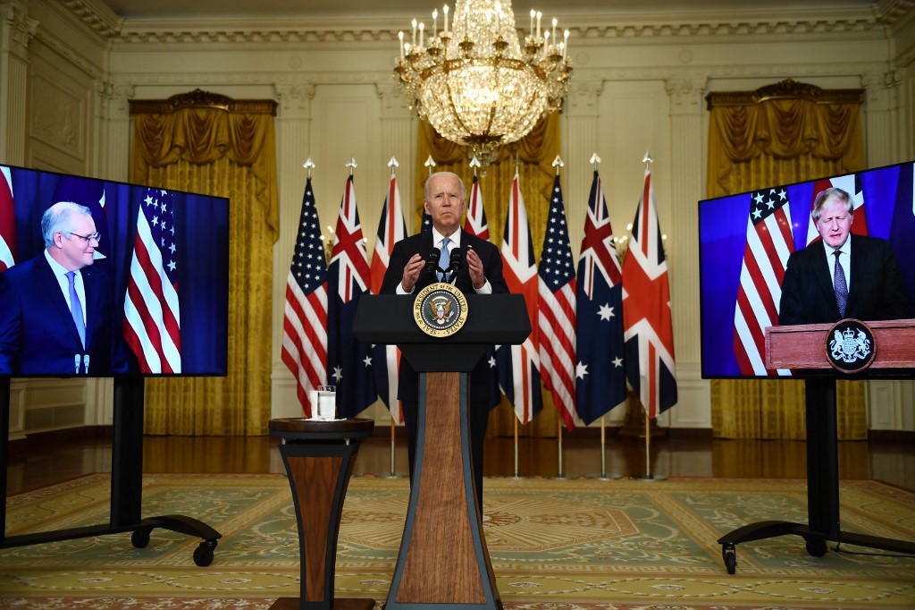 US President Joe Biden participates is a virtual press conference with British Prime Minister Boris Johnson (right) and Australian Prime Minister Scott Morrison in the East Room of the White House in Washington DC, September 15, 2021. — AFP pic