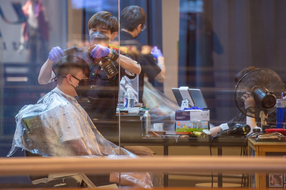 A man gets a haircut at a shopping mall in Kuala Lumpur during Phase Two of the National Recovery Plan on September 10, 2021. — Picture by Shafwan Zaidon
