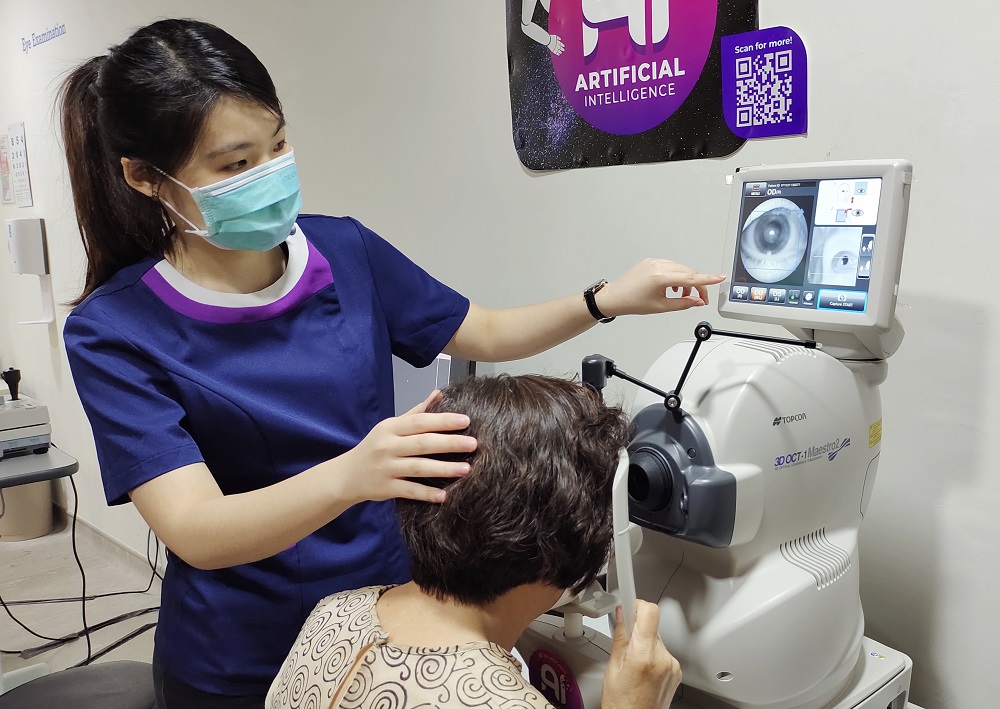 An optometrist checks a patient's retina and optic nerve using the OCT machine. ― Picture courtesy of VISTA Eye Specialist 