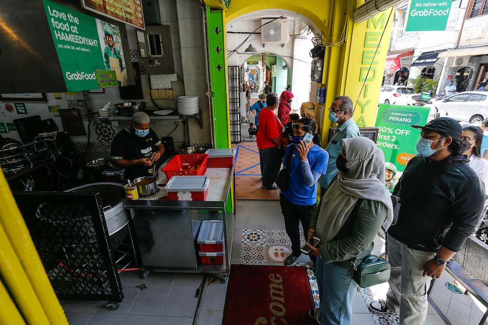 Customers wait for their turn to be served at Hameediyah Nasi Kandar in George Town, Penang October 22, 2021. u00e2u20acu201d Picture by Sayuti Zainudin