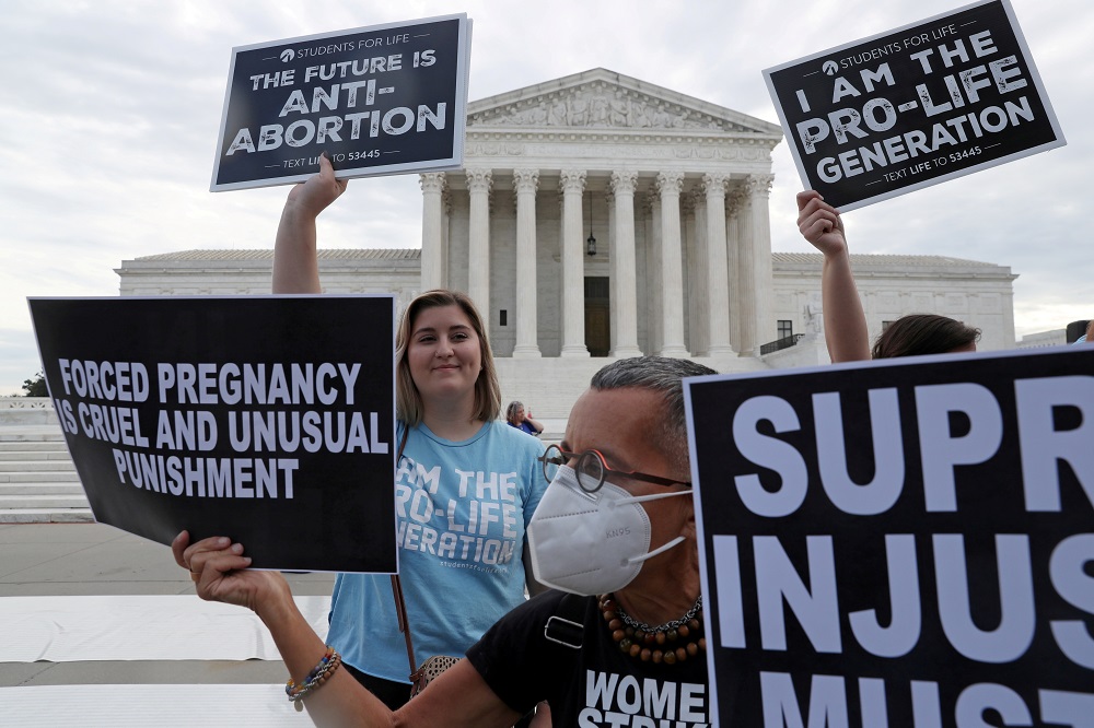 Hannah Wolfe, left, protests against abortion rights as Laurie Arbeiter protests for abortion rights in front of Wolfe, outside of the US Supreme Court building in Washington October 4, 2021. u00e2u20acu2022 Reuters file pic