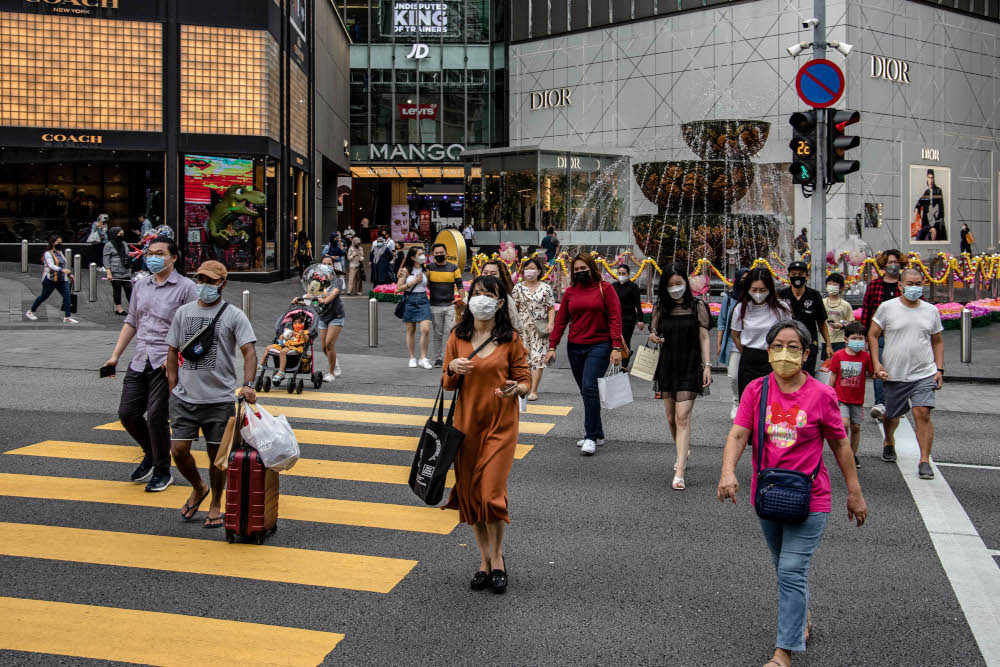 People are seen wearing protective masks as they walk along the Bukit Bintang shopping area in Kuala Lumpur, October 28, 2021. — Picture by Firdaus Latif