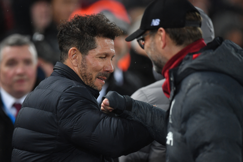 Atletico Madrid coach Diego Simeone and Liverpool manager Jurgen Klopp gesture during the Uefa Champions league Round of 16 second leg football at Anfield in Liverpool, March 11, 2020. — AFP pic