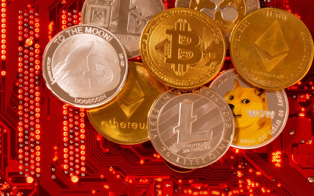 Representations of cryptocurrencies Bitcoin, Ethereum, DogeCoin, Ripple, Litecoin are placed on PC motherboard in this illustration taken June 29, 2021.  — Reuters pic
