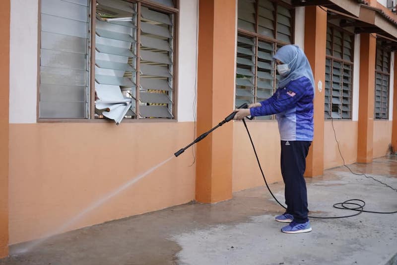 Malaysians mocked Women, Family and Community Development Minister Datuk Seri Rina Mohd Harun for seemingly hosing down already-clean drains. — Picture courtesy of Facebook/Rina Mohd Harun