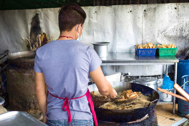 Frying customer’s 'yong tau foo' in a large wok of hot oil.