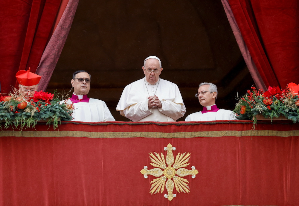 Pope Francis stands on the main balcony of St. Peteru00e2u20acu2122s Basilica to deliver his traditional Christmas Day Urbi et Orbi speech to the city and the world from the Vatican, December 25, 2021. u00e2u20acu201d Reuters picnnn