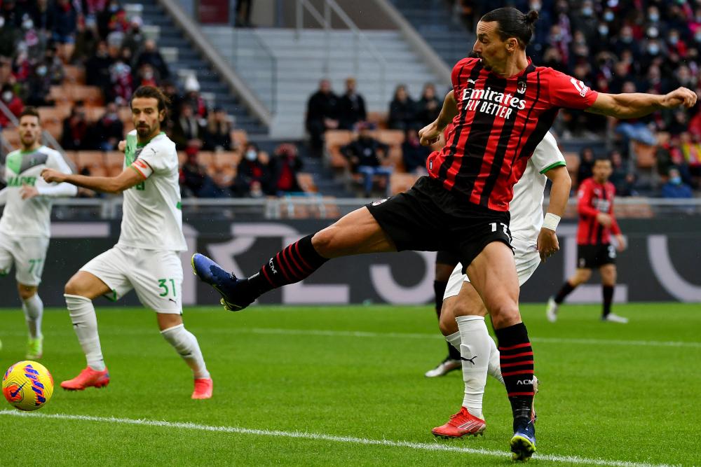 AC Milan forward Zlatan Ibrahimovic fights for the ball with Sassuolo defender Gian Marco Ferrari during the Italian Serie A football at the San Siro stadium in Milan, November 28, 2021. — AFP pic