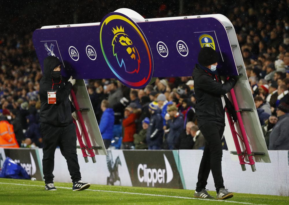 Ground staff carry the Premier League boarding off the pitch before the game between Leeds United and Crystal Palace at Elland Road, Leeds November 30, 2021. — Reuters pic