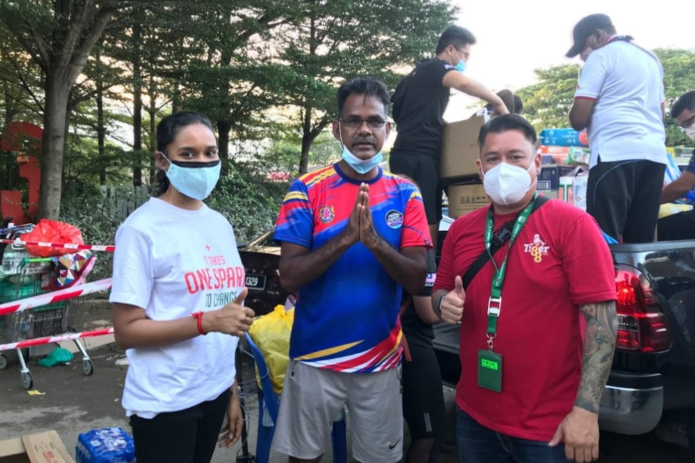 Shah Alam city councillor Pappa Raidu Veraman (centre) receiving the aid from representatives of Heineken Malaysia. u00e2u20acu201d Picture courtesy of Heineken Malaysia 