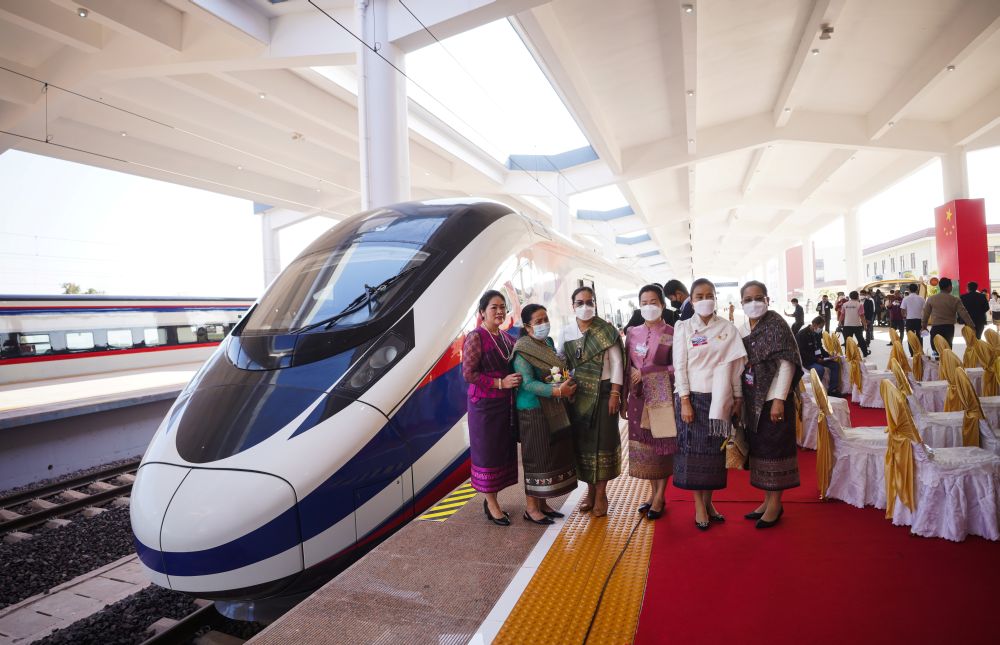 Women pose next to a train one day prior to the handover ceremony of the high-speed rail project linking the Chinese southwestern city of Kunming with Vientiane, Laos December 2, 2021. — Reuters pic