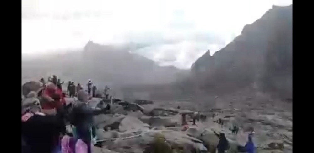 A screen capture of a video shared on WhatsApp said to be of snow on Mount Kinabalu, showing a thin blanket of snow. u00e2u20acu201d Borneo Post Online pic