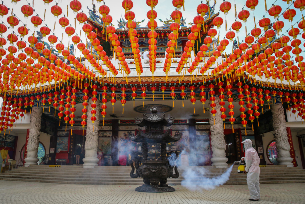 A temple worker sprays disinfectant at the Thean Hou Temple in Kuala Lumpur, January 19, 2022. u00e2u20acu201d Picture by Yusof Mat Isa