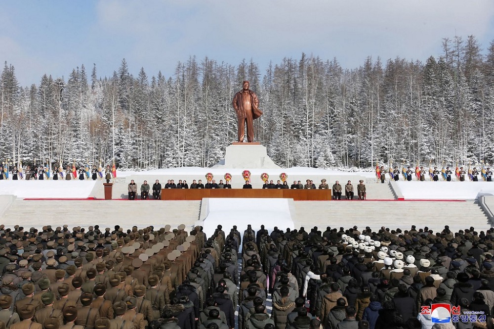 This picture shows North Korean leader Kim Jong-un (centre) attending a national meeting to celebrate 80th birth anniversary of chairman Kim Jong-il (in front of his statue) in Samjiyon City February 15, 2022. u00e2u20acu201d Picture by STR/KCNA VIA KNS /AFP