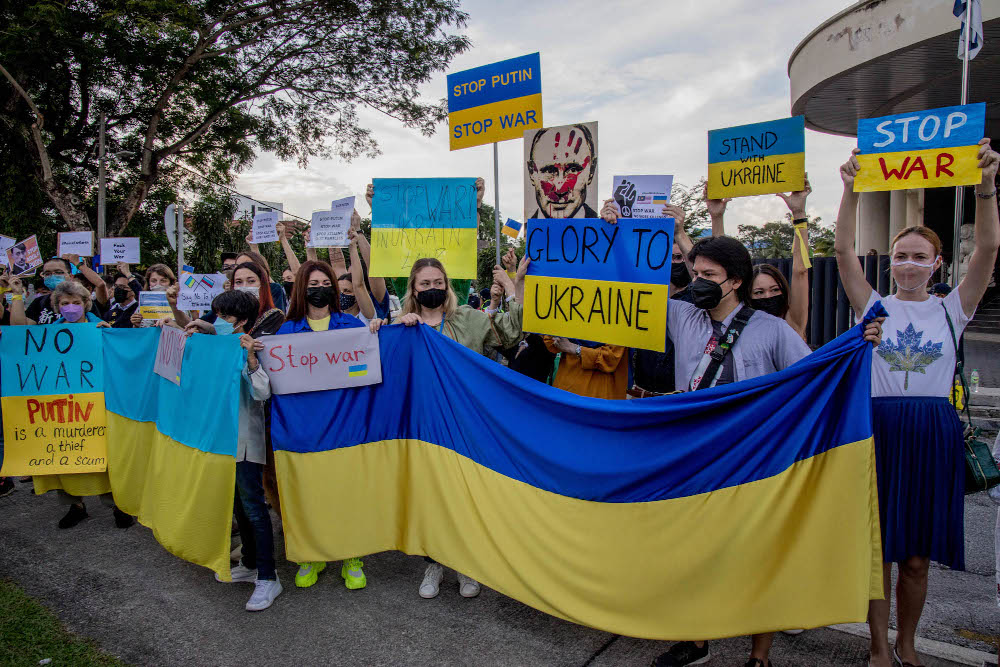 Demonstrators hold placards during a protest against Russia’s invasion of Ukraine, in front of the Russian embassy in Kuala Lumpur on February 28, 2022. — Picture by Firdaus Latif 