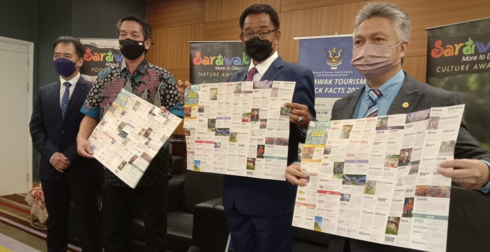 Datuk Seri Abdul Karim Rahman Hamzah (2nd right) showing the newly launched Calendar of Events 2022 at the press conference, accompanied by Datuk Snowdan Lawan on his left, Dennis Ngau on his right and Hii Chang Kee. u00e2u20acu201d Borneo Post Online pic 