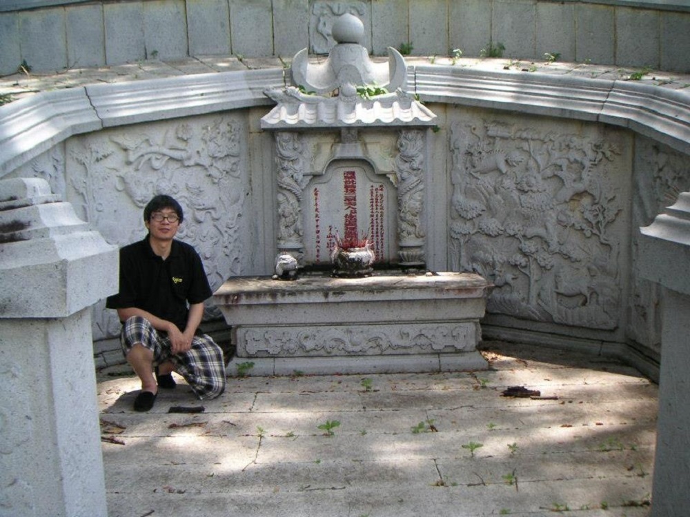 A descendant of Chung Keng Quee and Foo Teng Nyong, Jeffery Seow, at the tomb many years ago. u00e2u20acu2022 Picture courtesy of Jeffery Seow