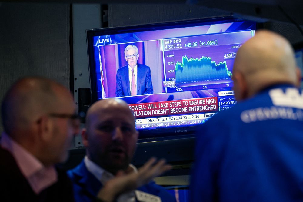 Traders work, as Federal Reserve Chair Jerome Powell is seen on a screen delivering remarks, at the New York Stock Exchange in New York CityMarch 16, 2022. u00e2u20acu201d Reuters pic