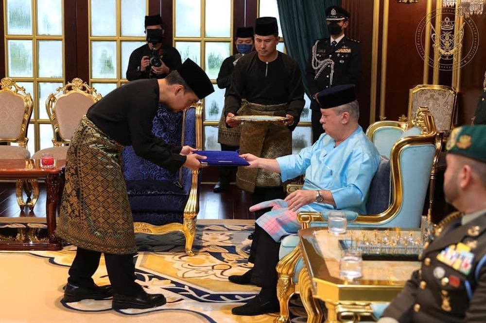 Newly-minted Johor Mentri Besar Datuk Onn Hafiz Ghazi receiving his letter of appointment from Johor Ruler Sultan Ibrahim Sultan Iskandar at the swearing-in ceremony at Istana Bukit Serene March 15, 2022. u00e2u20acu201d Picture courtesy of the Johor Royal Press Offi