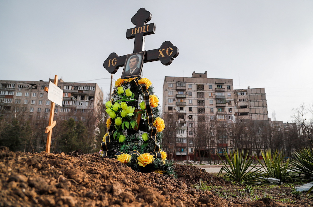 Graves of civilians killed during Ukraine-Russia conflict are seen next to apartment buildings in the southern port city of Mariupol, Ukraine April 10, 2022. u00e2u20acu201d Reuters pic